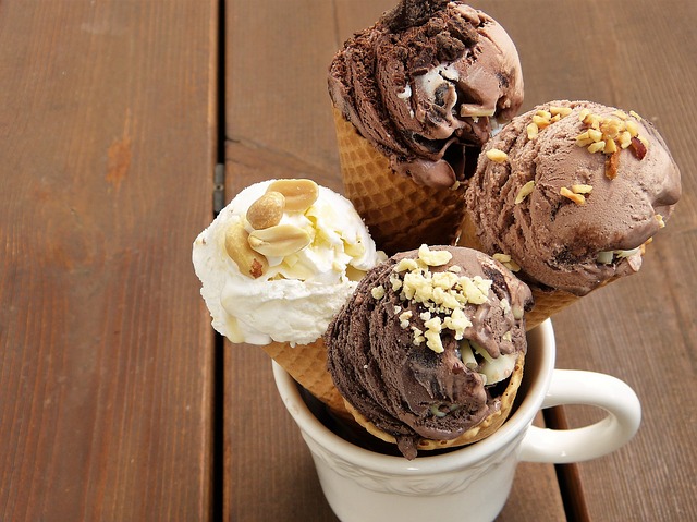 four ice cream cones setting in a cup